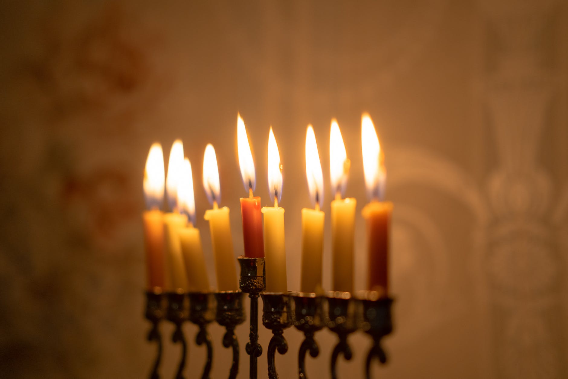 lighted candles on black metal candle holder