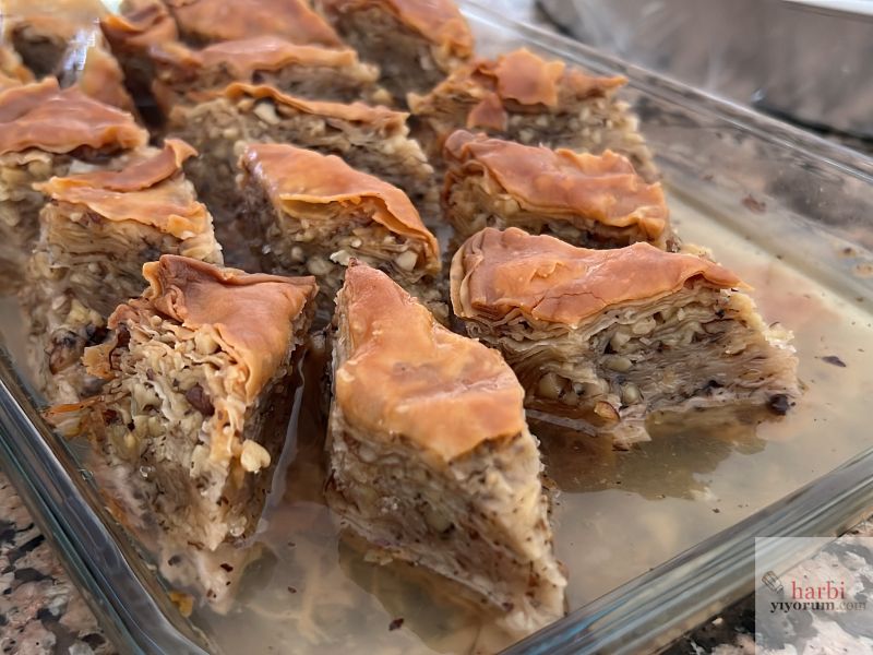 Teslime Cura tarafından hazırlanan, incecik yufkalarla ve bol cevizle yapılmış geleneksel ev baklavası. Yeşilyurt Köyü'ndeki Komşu Meze'de sunulan bu tatlı, Kazdağları'nın otantik lezzetlerinden biri.